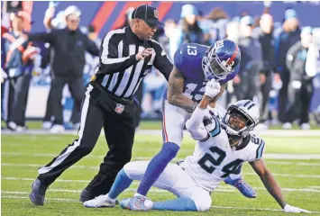  ?? JULIE JACOBSON, AP ?? An official tries to separate Giants wide receiver Odell Beckham Jr. ( 13) and Panthers cornerback Josh Norman ( 24) on Dec. 20, 2015, as they battle in the first half.