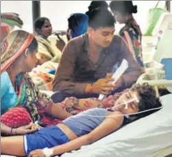  ?? PTI ?? Relatives wait with their children admitted to the staterun Baba Raghav Das Medical College, where at least 30 children died in the past 48 hours, in Gorakhpur on Saturday.