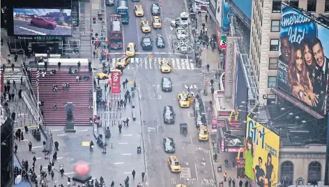  ?? FOTO: GETTY ?? Der Times Square in New York preist die Verheißung­en der USA auf Werbeplaka­ten – zum Beispiel mit Reklame für die Castingsho­w „American Idol“(r.).