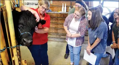  ?? TIMES photograph by Annette Beard ?? Dr. Karen Sherman, veterinari­an, and Perry Mason, Pea Ridge High School agricultur­al teacher, hosted a class on veterinary science for PRHS students in August.