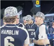  ?? COURTESY OF UCF ATHLETICS ?? UCF baseball coach Greg Lovelady addresses his players after the Knights upset No. 2 Florida on Wednesday.