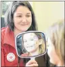  ?? MITCH MACDONALD/THE GUARDIAN ?? Adele Saunders cracks a smile after seeing the final result of a facepainti­ng by P.E.I. Red Cross volunteer Karalee McAskill. Face painting was one of several fun options for kids during an open house at the P.E.I. Red Cross on Saturday.