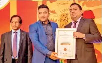  ??  ?? Emerging Media Founder and Managing Director Sanjeewa Rajapakshe receiving the award from Education Minister Akila Viraj Kariyawasa­m