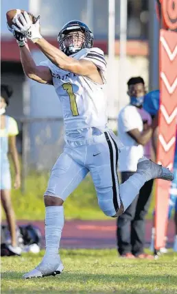  ?? MICHAEL LAUGHLIN/SUN SENTINEL ?? TRU Prep Academy receiver Brandon Inniss catches a pass and heads to the endzone against Christian Academy on Sept. 24.