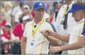  ?? CHARLIE NEIBERGALL — THE ASSOCIATED PRESS ?? Team Europe captain Padraig Harrington talks to Ian Poulter during a Ryder Cup singles match.