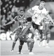  ?? ZAC GOODWIN AP ?? Tottenham’s Harry Kane, right, and Crystal Palace’s Nathaniel Clyne vie for the ball in Wednesday’s match.