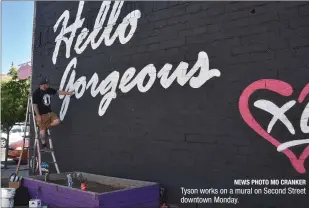  ?? NEWS PHOTO MO CRANKER ?? Tyson works on a mural on Second Street downtown Monday.