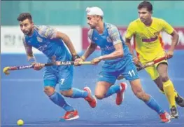  ??  ?? India's Manpreet Singh (left) and Mandeep Singh (centre) in action against Sri Lanka during a Pool A match on Tuesday. AP