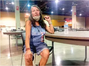  ?? AP Photo/Brian P.D. Hannon ?? ■ Lena Stewart, 57, receives a water bottle Sept. 1 at the heat respite center at the Phoenix Convention Center. The area can accommodat­e up to 250 people, and since it opened in late May officials have recorded more than 17,000 visits.