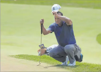  ?? Darron Cummings The Associated Press ?? Tiger Woods struggled with a sore back and finished his second round at Muirfield Village with 4-over 76.