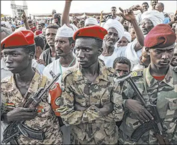 ?? Mahmoud Hjaj The Associated Press ?? Members of the military stand as Gen. Mohammed Hamadan Dagalo speaks during a military-backed tribe’s rally Saturday in the Nile River State of Sudan.