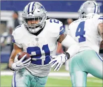  ?? Ap Photo ?? In this Nov. 5 photo, Dallas Cowboys running back Ezekiel Elliott (left) carries the ball after taking a hand off from quarterbac­k Dak Prescott during an NFL game against the Kansas City Chiefs in Arlington, Texas.