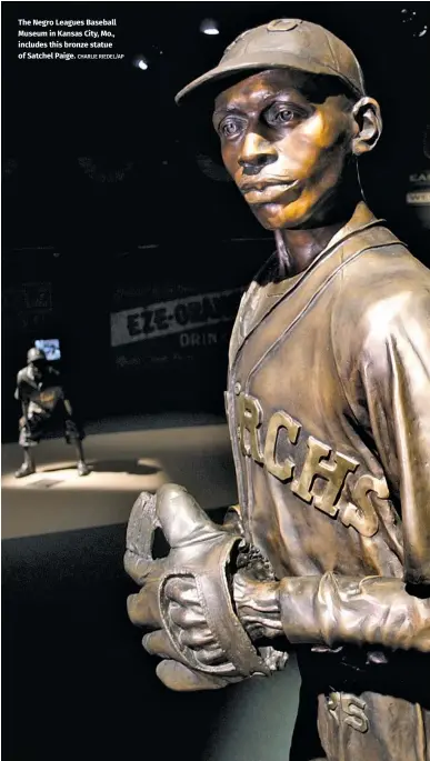  ?? CHARLIE RIEDEL/AP ?? The Negro Leagues Baseball Museum in Kansas City, Mo., includes this bronze statue of Satchel Paige.