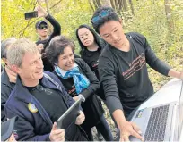  ??  ?? Ms Preeyanart, B.Grimm Group CEO Harald Link (left) and employees work on a reforestat­ion project.