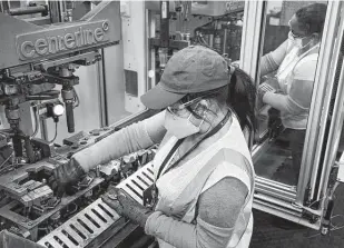  ?? Dallas Morning News file photo ?? Sonia Benitez, left, and Isabel Rosario work at Grand Prairie’s Flex-N-Gate, an SUV parts supplier. Texas manufactur­ing executives recently reported big gains in output and new orders.