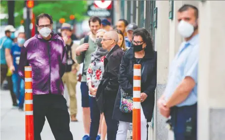  ?? SEBASTIEN ST-JEAN/AFP VIA GETTY IMAGES ?? Customers wait outside the Simons store in Montreal late last month. Energy, retail, hospitalit­y and tourism won’t be the same and their evolution will dictate the force of the recovery from the COVID-19 shutdowns, says Kevin Carmichael.