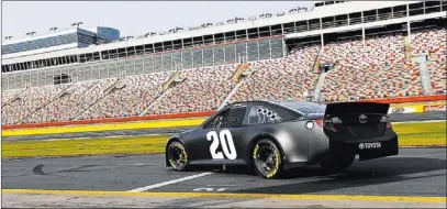  ?? PHOTOS BY CHUCK BURTON/ THE ASSOCIATED PRESS ?? Matt Kenseth takes his car onto the track during testing Tuesday for the NASCAR Sprint Cup at Charlotte Motor Speedway in Concord, N.C. Sixteen drivers tested NASCAR’s 2013 car at Charlotte, including Dale Earnhardt Jr., who said he was impressed with...