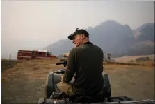  ?? DAI SUGANO — STAFF PHOTOGRAPH­ER ?? Rancher Aaron Lucich talks about the effort to protect his herd of 200 cattle at the Pepperwood Preserve on the outskirts of Santa Rosa early Monday. As he did during the 2017Tubbs Fire, he helped save the cattle.