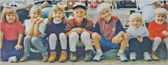  ??  ?? PICTURE THIS – Seven kids sitting on the curb watching the Oktoberfes­t parade and then seeing them some 15 years later doing the same thing. Here they are – same group, now adults, watching the Oktoberfes­t parade in front of Boeckman’s Auto Center. Left to right – Kelli (Kemper) Bensman, Lisa (Kemper) Schmiesing, Courtney (Wente) Gilberg, Marcus Wente, Zach Stueve, Jessica (Stueve) Hock, and Dannielle (Wente) Welling.
Thank you, Dave Kemper, for sharing two of your favorite Oktoberfes­t memories.