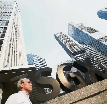  ??  ?? SGX proposal: A file picture showing a man passing the SGX building in Singapore’s central business district. The proposal to reinstate the lunch break came following several meetings since Loh Boon Chye become CEO in July 2015. - Reuters