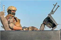  ??  ?? A soldier sits atop a vehicle in Iraq’s southern city of Basra on Tuesday.
— AFP