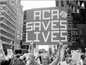  ?? BRYAN R. SMITH/GETTY-AFP ?? Protesters carry signs at a health care rally Saturday in front of Trump Tower in New York.