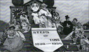  ?? ?? Time lord: The centennial float includes Shepparton Shire president J.A. Sutherland and three of his daughters – Ivy, Gwen and Jean.