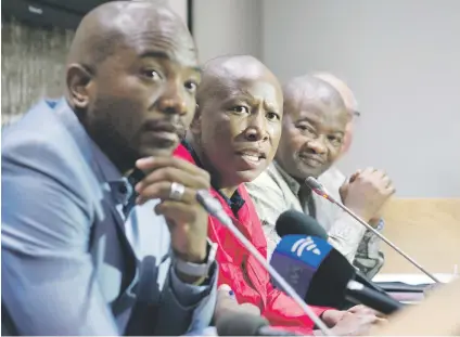  ?? Picture: AFP ?? UNITED FRONT. EFF party leader Julius Malema speaks flanked by DA party leader Mmusi Maimane and United Democratic Movement leader Bantu Holomisa.