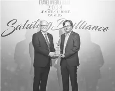  ??  ?? Ian Jarrett, editor at Large, Travel Weekly Asia (left) presents the award to Kurniawan at the ceremony.