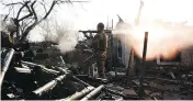  ??  ?? A Ukrainian serviceman fires a grenade launcher during fighting with pro-Russian separatist­s in March. Despite an armistice, the war of attrition has been growing.