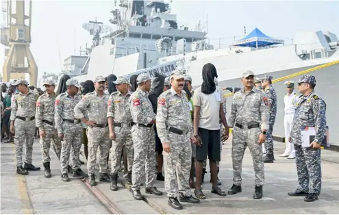  ?? INDRANIL MUKHERJEE/AGENCE FRANCE-PRESSE ?? ACCUSED Somali pirates escorted by soldiers wait to board a police van at the Indian naval dockyard in Mumbai on 23 March 2024. The pirates were apprehende­d when naval commandos recaptured a hijacked bulk carrier and rescued several hostages.