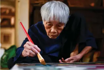  ?? — AFP photos ?? Bich painting at her house in Bac Ninh province, east of Hanoi.