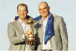  ??  ?? NEWPORT: In this Monday, Oct. 4, 2010 file photo, Europe’s Peter Hanson, left, and assistant captain Thomas Bjorn hold the trophy after Europe won the 2010 Ryder Cup golf tournament at the Celtic Manor Resort in Newport, Wales. Bjorn is the first...