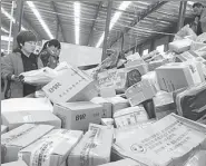  ?? WANG BIAO / FOR CHINA DAILY ?? Workers sort out packages at an express delivery company in                                                                   