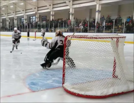  ?? CHRIS LILLSTRUNG — THE NEWS-HERALD ?? Brush goaltender Mike Kornet takes warmup shots before a game Dec. 3 against Brooklyn.