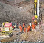  ?? — AFP ?? QIXIA, China: Members of a rescue team work at the site of a gold mine explosion where 22 miners are trapped undergroun­d in Qixia.