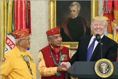  ?? ASSOCIATED PRESS ?? President Donald Trump, right, meets with Navajo Code Talkers Peter MacDonald, center, and Thomas Begay, left, in the Oval Office of the White House in Washington Monday.