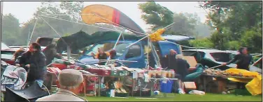  ??  ?? Pandemoniu­m: The freak wind rips away awnings as visitors make a dash for safety