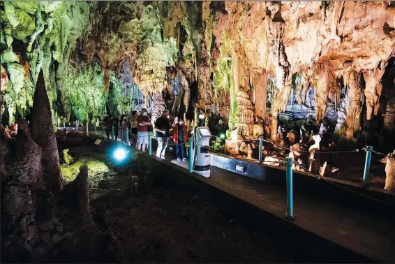  ?? (AP/Giannis Papanikos) ?? Persephone guides visitors Aug. 2 inside Alistrati Cave, about 84 miles northeast of Thessaloni­ki, Greece.