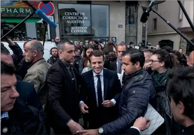  ??  ?? French presidenti­al candidate Emmanuel Macron (center) reacts during an election campaign event in Rodez, France on Friday.