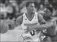  ?? The Associated Press ?? WRAPPING UP: Arkansas forward Adrio Bailey (2) reaches around and fouls Mississipp­i State guard Nick Weatherspo­on (0) in the second half of Tuesday’s NCAA basketball game in Starkville, Miss. Bailey came off the bench to score 10 points while grabbing...