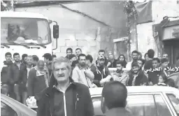  ?? Syrian Central Military Media via AP ?? This frame grab from video provided by the government-controlled Syrian Central Military Media shows Syrian citizens gather around buses Friday as they leave from Madaya, an opposition-held town near Damascus. The Syrian government and rebels began a...