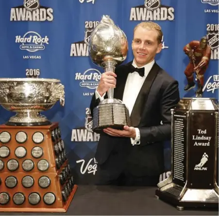  ?? JOHN LOCHER/THE ASSOCIATED PRESS ?? HARDWARE HAUL The Blackhawks’ Patrick Kane was the big winner at the NHL awards ceremony on Wednesday night in Las Vegas. Kane won the Hart Trophy as the league’s MVP, as well as the Art Ross and Ted Lindsay trophies. More on S2.