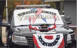  ??  ?? Veterans are welcomed in their cars to receive a Veterans Day breakfast outside the Baldwin Community Center in Stratford on Wednesday.