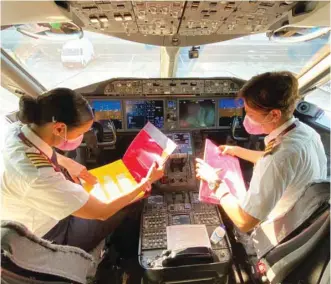  ??  ?? Left: Women power in full strength at Hamad Internatio­nal Airport ahead of the flight.
Right: The special flight had pink amenity kits and meals onboard, which passengers can also enjoy for the rest of October.
Below: The flight was operated with a Boeing 787 Dreamliner.