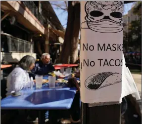  ?? (AP/Eric Gay) ?? A sign requiring masks is seen Wednesday at a restaurant on the River Walk in San Antonio. Gov. Greg Abbott said Texas is lifting its mask mandate and business capacity limits next week.