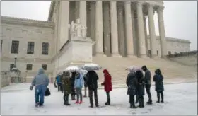  ?? J. SCOTT APPLEWHITE ?? Visitors wait to enter the Supreme Court as a winter snow storm hits the nation’s capital making roads perilous and closing most Federal offices and all major public school districts, on Capitol Hill in Washington, Wednesday, Feb. 20, 2019. The Supreme Court is ruling unanimousl­y that the Constituti­on’s ban on excessive fines applies to the states. The outcome Wednesday could help an Indiana man recover the $40,000Land Rover police seized when they arrested him for selling about $400worth of heroin.