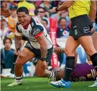  ?? PHOTOSPORT ?? Issac Luke celebrayes after scoring a try for the Warriors in their win over the Broncos.