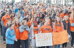  ?? BERNARD THOMAS/THE HERALD-SUN VIA THE ASSOCIATED PRESS ?? East Chapel Hill students take part in a student walkout on Wednesday in Chapel Hill, N.C.