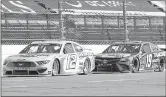  ?? STEVE HELBER — THE ASSOCIATED PRESS ?? Ryan Blaney (12) and Martin Truex Jr. (19) approach the third turn during a NASCAR Cup Series race Sunday at Martinsvil­le Speedway in Martinsvil­le, Va.